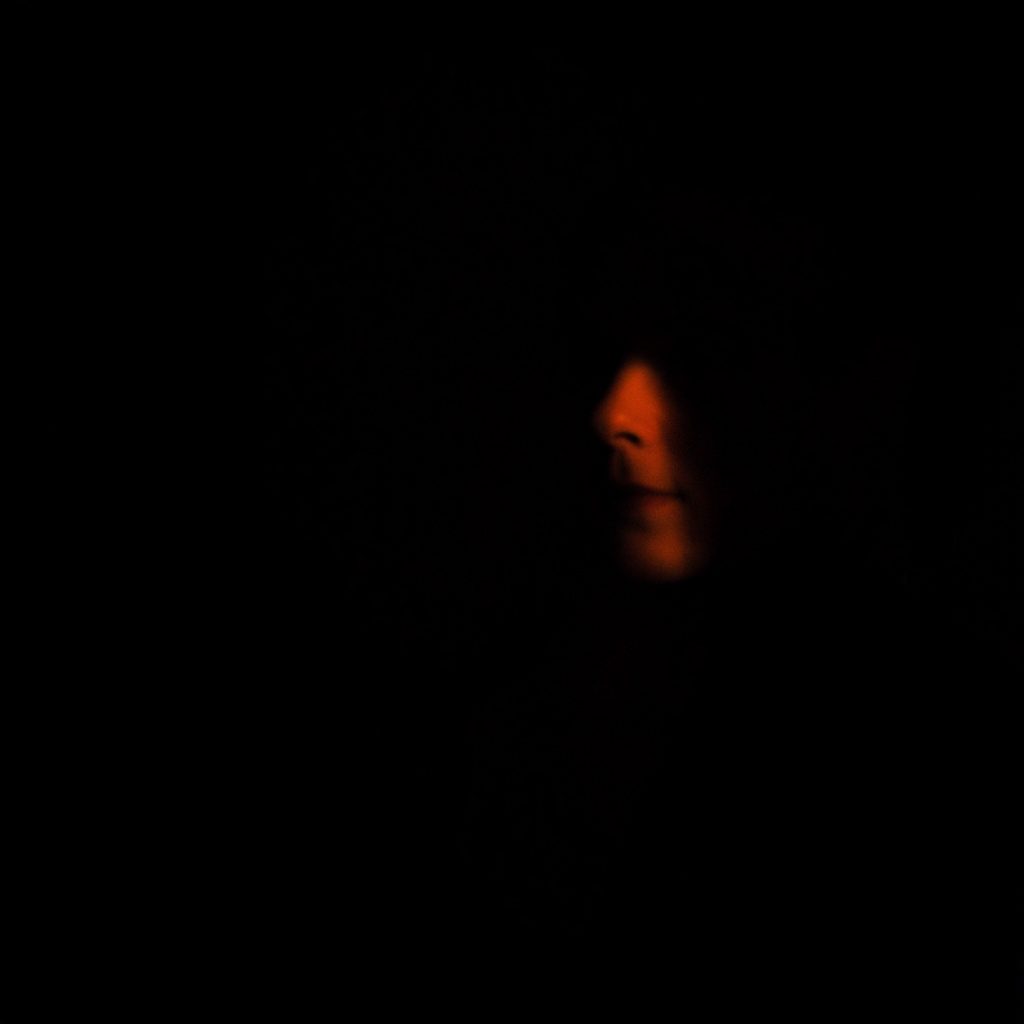 Moody low-key composition with deep shadows and subtle highlights suggesting craftsmanship